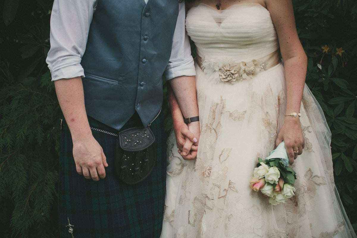 Bride and groom hold hands at wedding elopement at Glenisle Hotel on The Isle of Arran Scotland