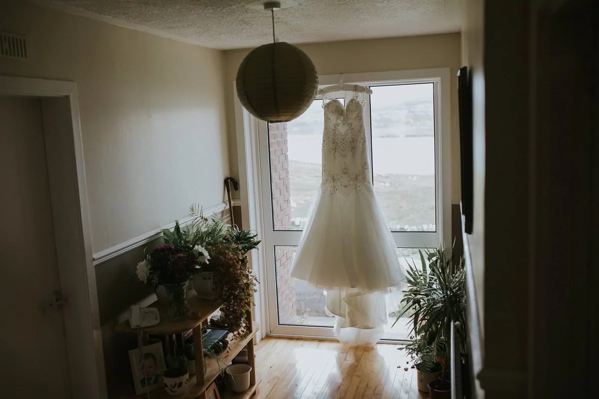 bride wedding dress hanging at home scotland